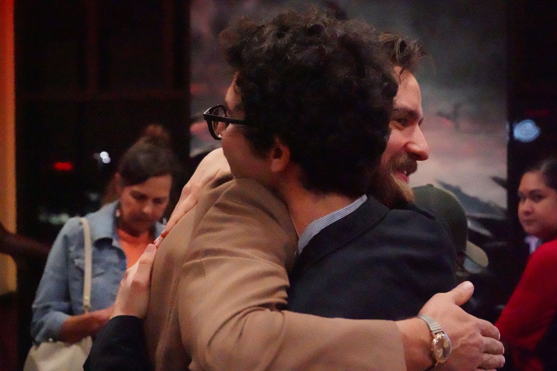 Two guests embracing at the festival reception