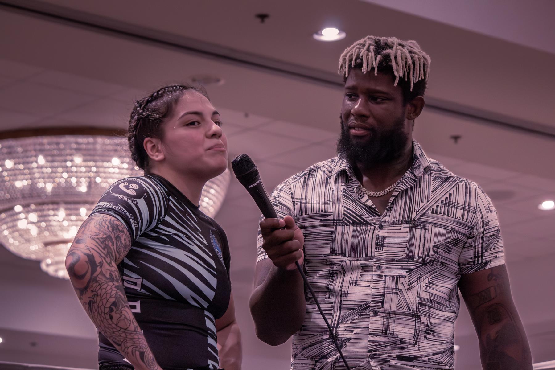 Fighter being interviewed with a microphone after her match
