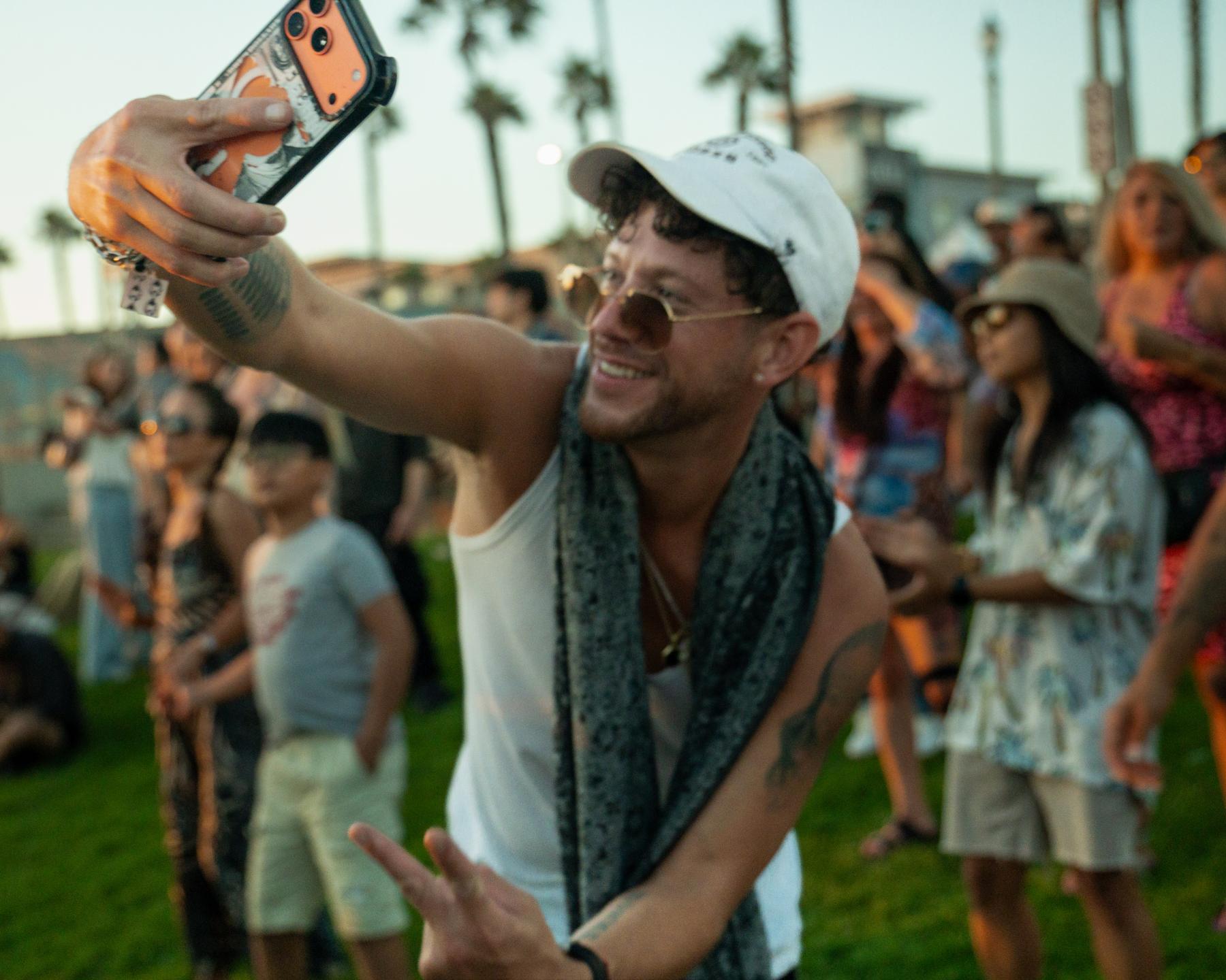 Guest taking a selfie in the crowd at the event