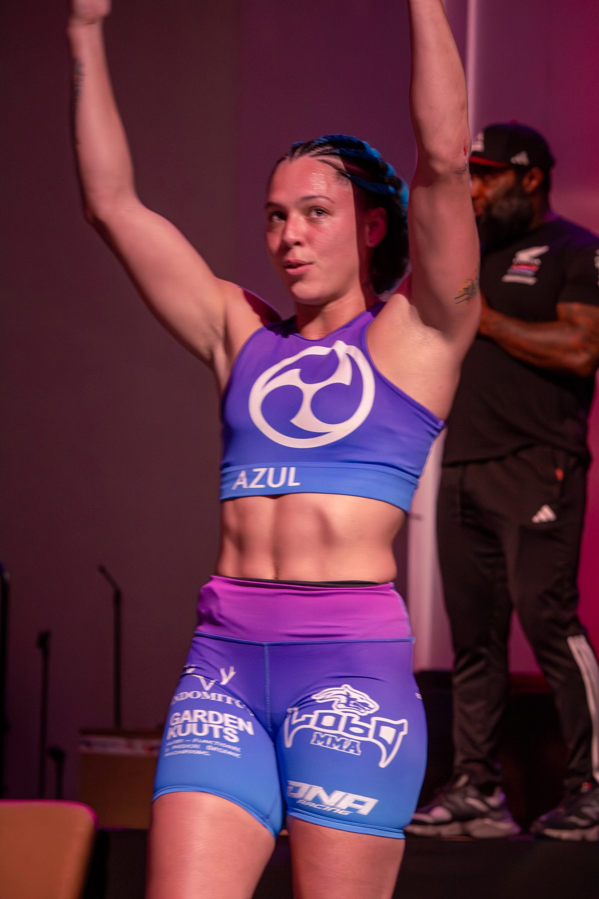 Fighter raising both arms after her match